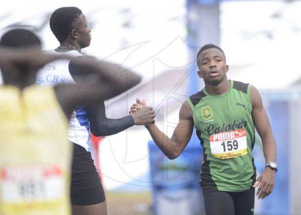 Shorn Hector/Photographer Dishaun Lamb of Calabar High (right) congratulated by Sandrey Davidson of St Catherine High after winning heat five of the boys class two 100 meter dash on day three of the ISSA/GraceKennedy Boys and Girls’ Athletics Championships held at the The National Stadium in Kingston on Thursday March 28, 2019
