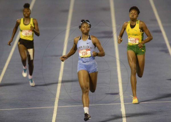Shorn Hector/Photographer Sprint sensation Kevona Davis of Edwin Allen High (center) strides to victory in semi final one of the girls class two 200 meters on day three of the ISSA/GraceKennedy Boys and Girls’ Athletics Championships held at the The National Stadium in Kingston on Thursday March 28, 2019