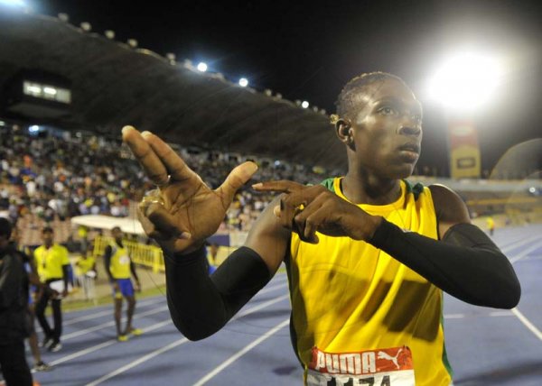 Shorn Hector/Photographer Antonio Watson of Petersfield celebrtes by "bussing a blank" after anchoring his team to victory in the boys 4x400 meter open on day three of the ISSA/GraceKennedy Boys and Girls’ Athletics Championships held at the The National Stadium in Kingston on Thursday March 28, 2019