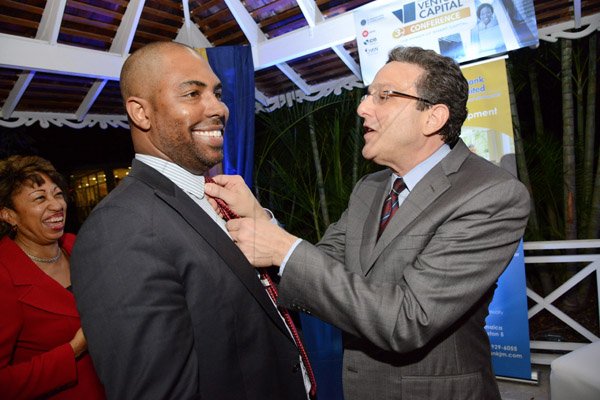 Rudolph Brown/ Photographer
Business Desk
Joseph Matalon, (right) chairman ICD Group Limited and Chairman DBJ fix Steven Whittingham, President, First Global Financial Services tie while Diane Edwards President of Jampro at the Development Bank of Jamaica's Venture Capital official Opening and Cocktail Reception at the Jamaica Pegasus on Monday, March 7, 2016