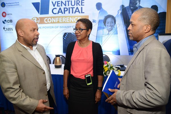Rudolph Brown/ Photographer
Business Desk
Audrey Richards project coordinator Jamaica Venture Capital Programme, chat with Michael Preaton, (left) VP, Government Affairs and Customer Experience of Paradisexpress and Garry Anthony Johnson, President and CEO of Paradisexpress at the Development Bank of Jamaica's Venture Capital Conference Pre-Conference Workshop at the Jamaica Pegasus on Monday, March 7, 2016