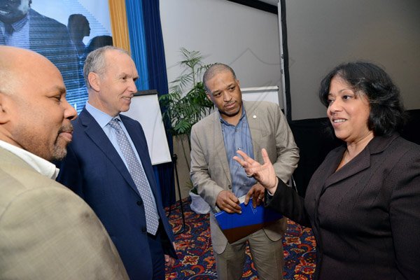 Rudolph Brown/ Photographer
Business Desk
Hillary Alexander, Permanent Secretary chat with from left Michael Preaton, VP, Government Affairs and Customer Experience of Paradisexpress, Adam Nicolopoulos, Managing Director of ADN Capital Venture and Garry Anthony Johnson, President and CEO of Paradisexpress at the Development Bank of Jamaica's Venture Capital Conference Pre-Conference Workshop at the Jamaica Pegasus on Monday, March 7, 2016