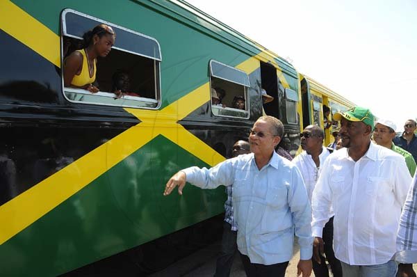 Ian Allen/Photographer
Prime Minister Bruce Golding ion his arrival at the Spanish Town Railway Station is being greeted by passengers on the Train travelling to Denbigh in Clarendon for the annual Denbigh Agricultural Show.