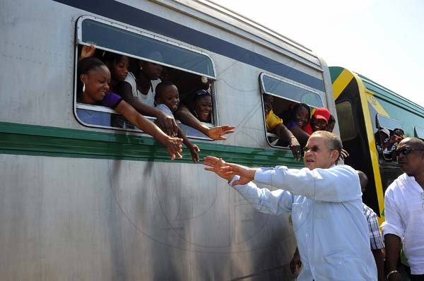Ian Allen/Photographer
Prime Minister Bruce Golding ion his arrival at the Spanish Town Railway Station is being greeted by passengers on the Train travelling to Denbigh in Clarendon for the annual Denbigh Agricultural Show.