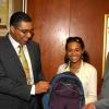 JIS Photo                                                                                                                                                                                                                                                         Minister of Education, Hon Andrew Holness (left)  and  Minister of State in the Ministry of Education, Hon. Gregory Mair (right), examine one of the backpacks that will be donated to  Denbigh High School, by  Project Co-ordinator of  Lili?s Backpack, Miss Lili Henry (centre), at the Ministry on June 30.