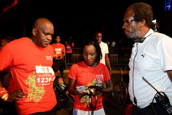 Winston Sill/Freelance Photographer
Digicel Foundation 5K Run/Walk for Special Needs, held on the Waterfront, Downtown Kingston on Saturday night  October 11, 2014. Here are Senate President Floyd Morris (left); Judine Hunter (centre), of Digicel Foundation; and ---??? Francis (right).