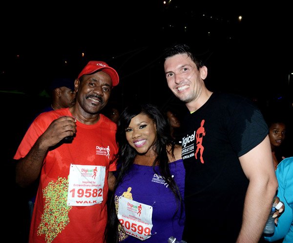 Winston Sill/Freelance Photographer
Digicel Foundation 5K Run/Walk for Special Needs, held on the Waterfront, Downtown Kingston on Saturday night  October 11, 2014. Here are Harry Smith (left); Miss Kitty (centre); and Peter  Lloyd (right), Marketing  Diredtor, Digicel.