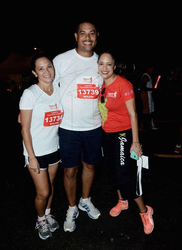 Winston Sill/Freelance Photographer
Digicel Foundation 5K Run/Walk for Special Needs, held on the Waterfront, Downtown Kingston on Saturday night  October 11, 2014. Here are ---??? (left); Mikael Phillips (centre); and Samantha Chantrelle (right).