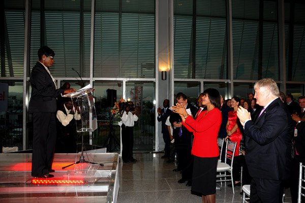 Winston Sill / Freelance Photographer
The Official Opening of Digicel Regional Headquarters by Prime Minister Portia Simpson-Miller, held at Ocean Boulevard on Tuesday March 19, 2013. Here the gathering applauding Debbie Williams (left), Head Receptionist, Digicel Group.