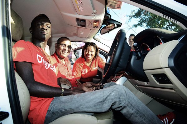 Winston Sill/Freelance Photographer
Shaquille Sewell enjoys the interior of his new Range Rover Evoque with Digicel distribution director, Patrick King and the company's recharge manager Annalise Harewood during her company's Christmas Promotion draw and handover ceremony at St. William Grant Park, West Parade on Wednesday.





 January 15, 2014.