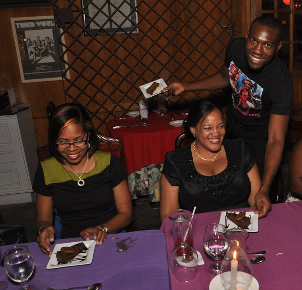 Jermaine Barnaby/Photographer
Hope Mc Millan- Cowan (right) and Simone Mahabeer as they are served dessert at The Gleaner's Pre-Restaurant Week Dinner Promotions 2013 with Karin Cooper and guests at  Red Bones on 
 Tuesday, November 5, 2013.