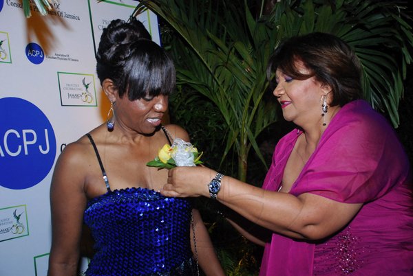 Colin Hamilton/Freelance Photographer
The Association of Consultant Physitians of Jamaica held it's 10th Annual President's Dinner in celebration of Jamaica's 50th Anniversary of Independence at the Terra Nova All Suites Hotel on Saturday September 8, 2012.

From left, President of the ACPJ, Dr. Rosemarie Wright-Pascoe is pinned with a corsage by Dr. Althea Aquart-Stewart.