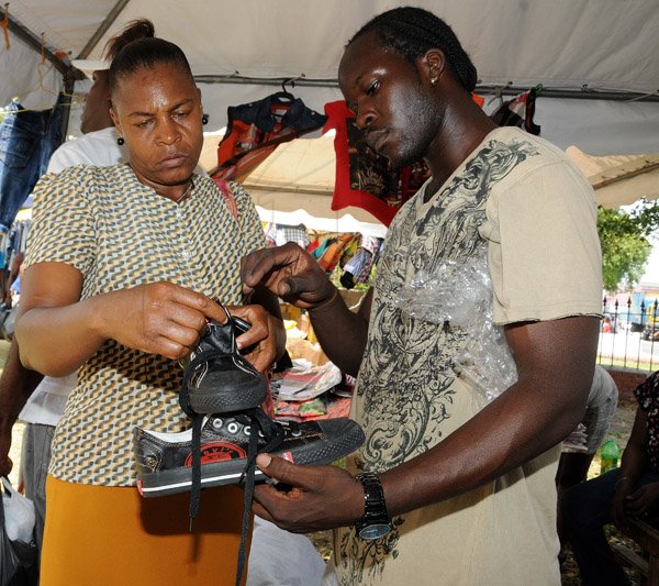 Gladstone Taylor / Photographer

Margaret Thorpe (left) is assisted by Andre Parker while shopping for shoes as seen at the downtown sizzling summer savings at st williams grant park yesterday