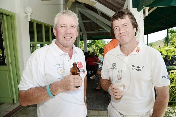 Rudolph Brown/Photographer
Ian Porton (right) and Tom Connor enjoy their drinks at yesterday's Duke of Edinburgh Golf Tournament at Caymanas Golf Club.