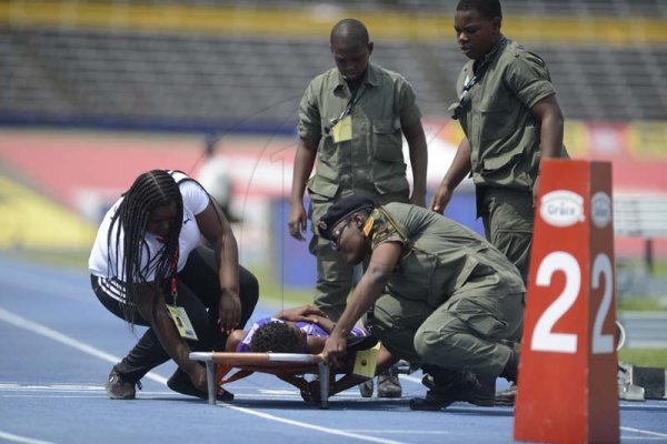 Shorn Hector/Photographer Medics attend to an injuried athlete on day two of the ISSA/GraceKennedy Boys and Girls’ Athletics Championships held at the The National Stadium in Kingston on Wednesday March 27, 2019