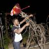 Shorn Hector/Photographer   Artist Toby Grant (in back) gets help from patron Kadeem Nooks to complete his sculpture of a six legged horse at the Earth Hour concert held at Ranny William Entertainment Centre on March 25, 2018