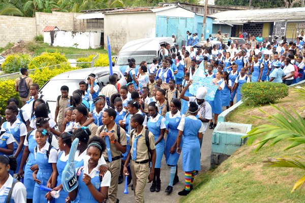 Jermaine Barnaby/Photographer
Students of Edwin Allen high as they march along the road in celebration  of their Champs win at the school on Monday March 30, 2015.