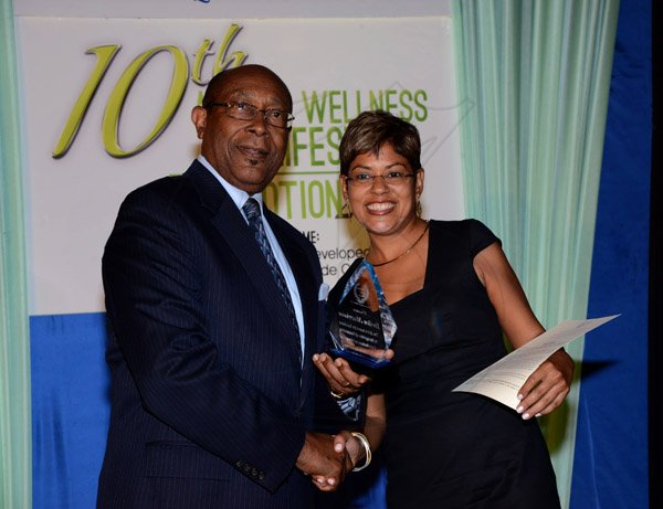 Winston Sill/Freelance Photographer
Environmental Health Foundation (EHF) 10th Annual Wellness and Lifestyle Awards Ceremony, held at Eden Gardens, Lady Muisgrave Road on Wednesday night April 30, 2014. Here Dr.Henry Lowe (left), Chairman, EHF Group, presents Deika Morrison (right) with her Award.