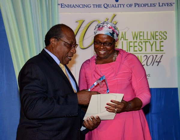 Winston Sill/Freelance Photographer
Environmental Health Foundation (EHF) 10th Annual Wellness and Lifestyle Awards Ceremony, held at Eden Gardens, Lady Muisgrave Road on Wednesday night April 30, 2014. Here Dr. Herbert Lowe (left), Deputy Chairman, EHF Group presents Bhondel Shirley-Atwater (right) with her Award.