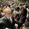 Gladstone Taylor / Photographer
Prime Minister Bruce Golding is flocked by hundreds of mourners during yesterday's funeral for his mother.