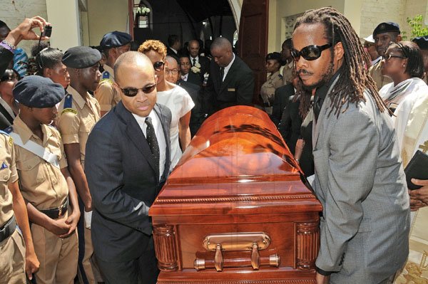 Gladstone Taylor/Photographer
Pall bearers, including Prime Minister Bruce Golding's son, Stephen (right), carry the coffin containing the body of Enid Golding out of the church.