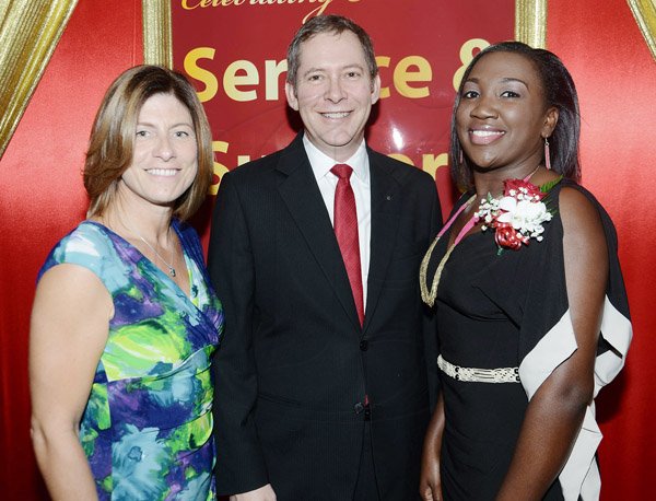 Rudolph Brown/Photographer
Bruce Bowen, president od CEO, Scotiabank enjoys pride of place bewtween Michele English, (left) president and COO Columbus Communications, Flow Jamaica and Kimone Whittick at the Scotiabank Group Celebrating Excellence Service and Support awards ceremony at Knutsford Court Hotel in Kingston on Saturday.

**********************************************************, May 18, 2013