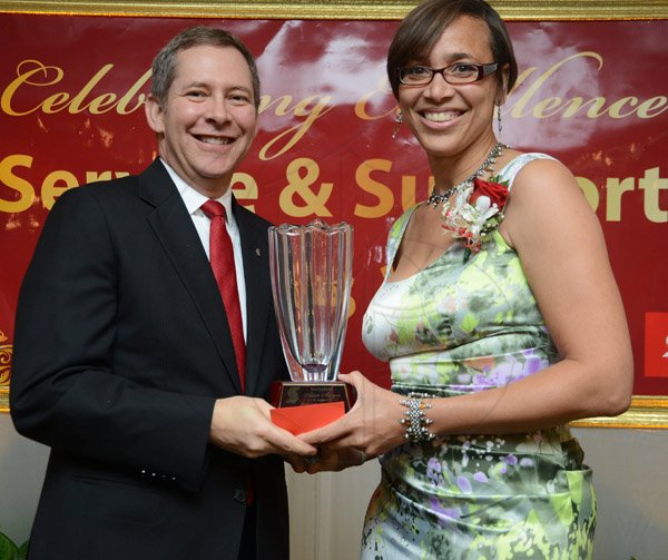 Rudolph Brown/Photographer
Bruce Bowen, President and CEO, Scotiabank Alison Morgan, winner of the top Manager award at the Scotiabank Group Celebrating Excellence Service and Support awards ceremony at Knutsford Court Hotel in Kingston on Saturday, May 18, 2013
