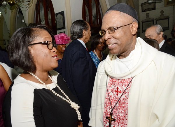 Rudolph Brown/Photographer
Lisa Bell, Managing Director, EXIM Bank greets Reverend Canon Major Sirrano Kitson at the EXIM Bank’s 30th anniversary church service at the St Andrew Parish Church on Sunday, May 1, 2016