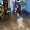 Norman Grindley/Chief Photographer
Harbour View resident Carole Thomas sweeps water from her home during the rains that affected the St Andrew community yesterday afternoon.