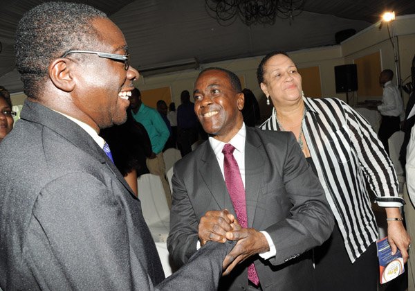 Rudolph Brown/ Photographer
Chief Judge Professor Hopeton Dunn and Wyvolyn Gager greets Arthur Hall at the Fair Play award of excellence 2013/2014 held at the Tera Nova Hotel, Kingston on September 16, 2014