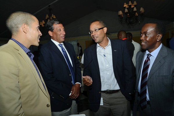 Rudolph Brown/Photographer
Christopher Levy, (second left) President and CEO chat with Christopher Barnes, (second right) Managing Director of The Gleaner, Saadiq Rodgers-King, (left) Chief Operating Officer of Nodeijitsu and Co-founder of Hot Potato and Professor Hopeton Dunn at the 12th Anniversary Awards Luncheon for presentation of the 2011/2012 Fair Play Awards at the Terra Nova Hotel on Tuesday, September 11-2012