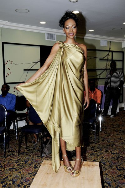 Winston Sill / Freelance Photographer
This flowing olive green dress worn by Daina Clarke lives up to its name, liquid olive. It was one of three pieces from the Fehmeka line, which will be shown in full at the upcoming Caribbean Fashionweek