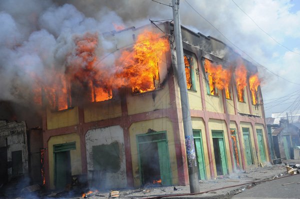 Norman Grindley/Chief Photographer
A major fire this afternoon destroyed several houses on Regent Street in downtown Kingston. Three fire units and a water truck arrived on the scene as fire personnel tried to contain the blaze September 26, 2012.