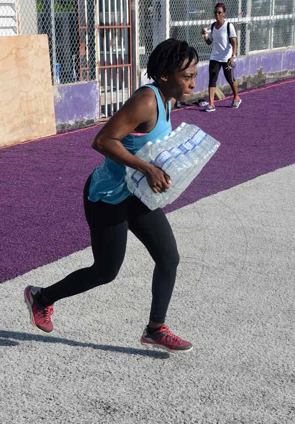 Lionel Rookwood/PhotographerThe Gleaner's Fit 4 Life Sweatfest at the Life Fit Training Centre, 15 3/4 Red Hills Road, St Andrew, with aerobics instructor O.J. O'Gilvie on Saturday, November 18, 2017. *** Local Caption *** Lionel Rookwood/PhotographerFaith Browne racing against the clock in the WATA challenge, sponsor of The Gleaner's Fit 4 Life.