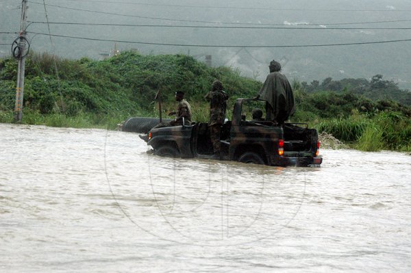 Adrian Frater photo 
A  Jamaica Defence Force (JDF) patrol unit braves the deluge along the Fairfield main road in Montego Bay, St James.