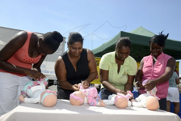 Gladstone Taylor / Photographer

l-r Samantha Johnson, Julie Lahla, Angela Anderson and Jennifer Gray all race to complete the diaper changing challenge as seen at the shoppers fair food month promotion in Harbour View on saturday