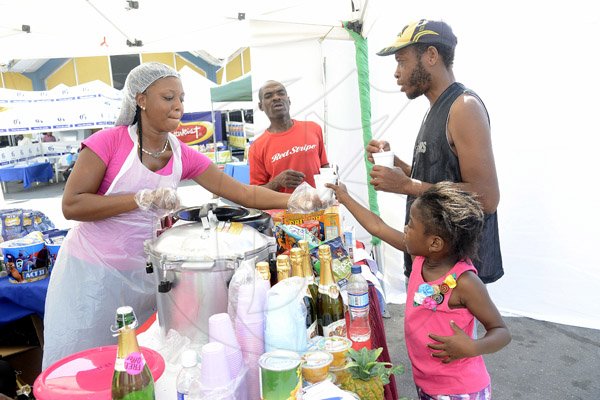 Gladstone Taylor / Photographer

Nickisha Clarke (left) hands Alicia Campbell a sample quaker oats porridge. Carol Bennet (2nd right) and Eddie Orville look on.

the shoppers fair food month promotion in Harbour View on saturday