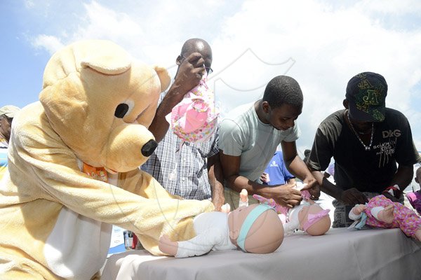 Gladstone Taylor / Photographer

l-r Cubbies Mascot, Ian Hudson, Rohan Cummings, and Hopeton Williams compete in the diaper changing competition as seen at the shoppers fair food month promotion in Harbour View on saturday