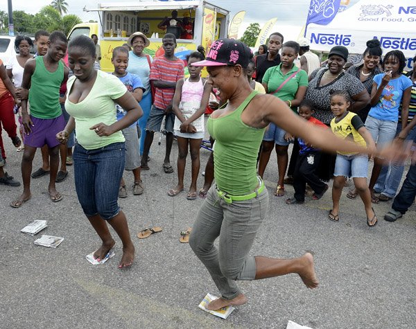 Gladstone Taylor / Photographer

Sasha-Gaye Savage (right) loses her balance in the news paper dance contest leaving Tashna Benett the victor as seen at the Gleaner company food moth promotion held at shoppers fair super market on brunswick avenue, spanish town on saturday