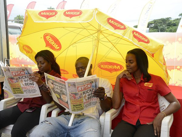 Gladstone Taylor / Photographer

These three Maggie representatives take a minute to check out the saturday star as seen at the Gleaner company food moth promotion held at shoppers fair super market on brunswick avenue, spanish town on saturday