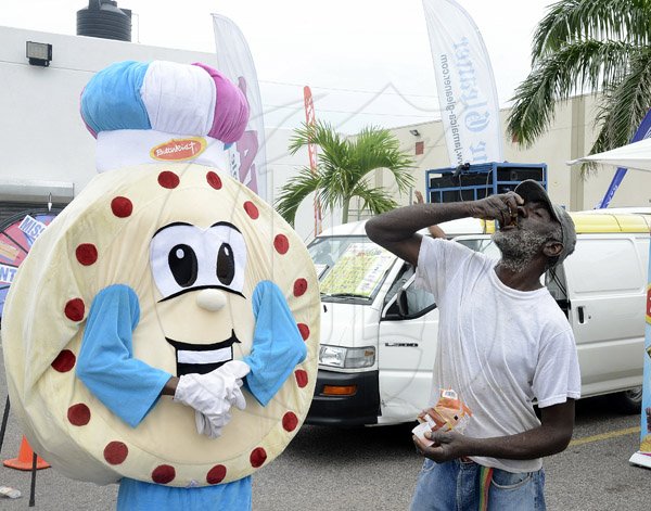Gladstone Taylor / Photographer

Herman Walcott (right) finishes his last cracker to emerge as the victor of the butterkist biscuit eating contest  contest  as seen at the Gleaner company food moth promotion held at shoppers fair super market on brunswick avenue, spanish town on saturday