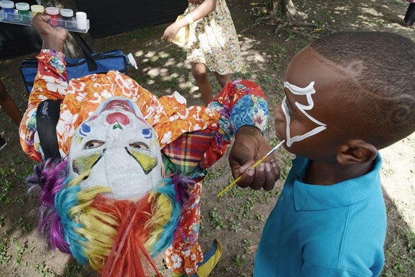 Rudolph Brown/ Photographer
Fransceen Francis, (left) and Rhyeo McCrea having fun with the Junkanoo at Funfest at Hope Gardens on Sunday, December 20, 2015