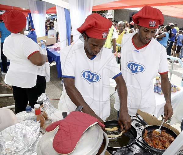 Gladstone Taylor / Photographer

From left: Team Eve's Taj McKenzie preparing festival while team captain Ferron 'Terrence' Williams prepares his French fried barbequed fish.