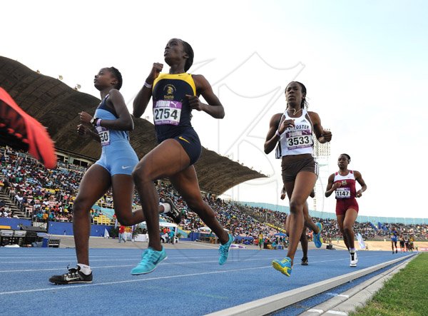 Ricardo Makyn/Staff Photographer 
Foreground at left is Edwin Allen's Teresha Jacobs runs with winner of the Women's Mile run Utech's Samntha James   at the 2015 Gibson/McCook relays held at the National Stadium on Saturday 28.2.2015