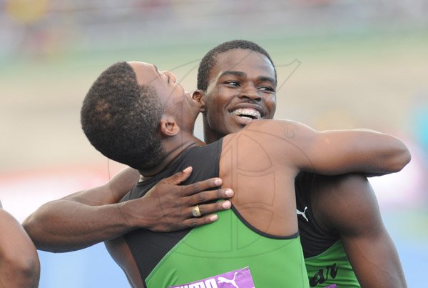 Ricardo Makyn/Staff Photographer 
Calabar's Jelani Walker and Michael Ohara embrace after their teams   victory in the Boys 4x100 at the 2015 Gibson/McCook relays held at the National Stadium on Saturday 28.2.2015