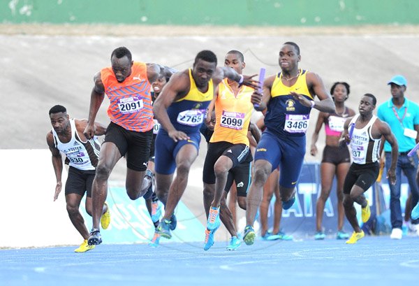Ricardo Makyn/Staff Photographer 
Racer's Lion's  Usain Bolt receives the Baton from Warren Weir as he treis to make up ground on Utech's Tyquendo Tracey  in the Men's  4x100 at the 2015 Gibson/McCook relays held at the National Stadium on Saturday 28.2.2015