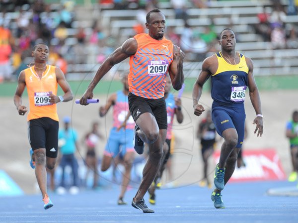 Ricardo Makyn/Staff Photographer 
Racer's Lion's  Usain Bolt  treis to make up ground on Utech's Tyquendo Tracey[out of picture]  in the Men's  4x100 at the 2015 Gibson/McCook relays held at the National Stadium on Saturday 28.2.2015