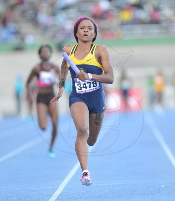 Ricardo Makyn/Staff Photographer 
Utech's Chanice Bonner anchoring her team to victory in the  Institutin women's  4x100 at the 2015 Gibson/McCook relays held at the National Stadium on Saturday 28.2.2015
