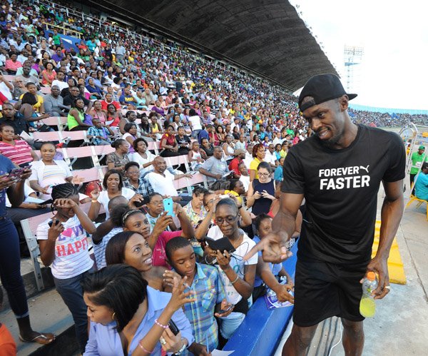 Ricardo Makyn/Staff Photographer 
  Usain Bolt taking time out for the fans  at the 2015 Gibson/McCook relays held at the National Stadium on Saturday 28.2.2015
