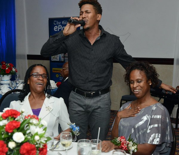 Ian Allen/Photographer
Gleaner Long Service Awards 2016.

Entertainer Mario Evons (centre) serenades Michelle Curry (right) and Joan Kerr during The Gleaner's Long Service Awards Luncheon at the Pegasus Hotel in Kinston on Tuesday.
